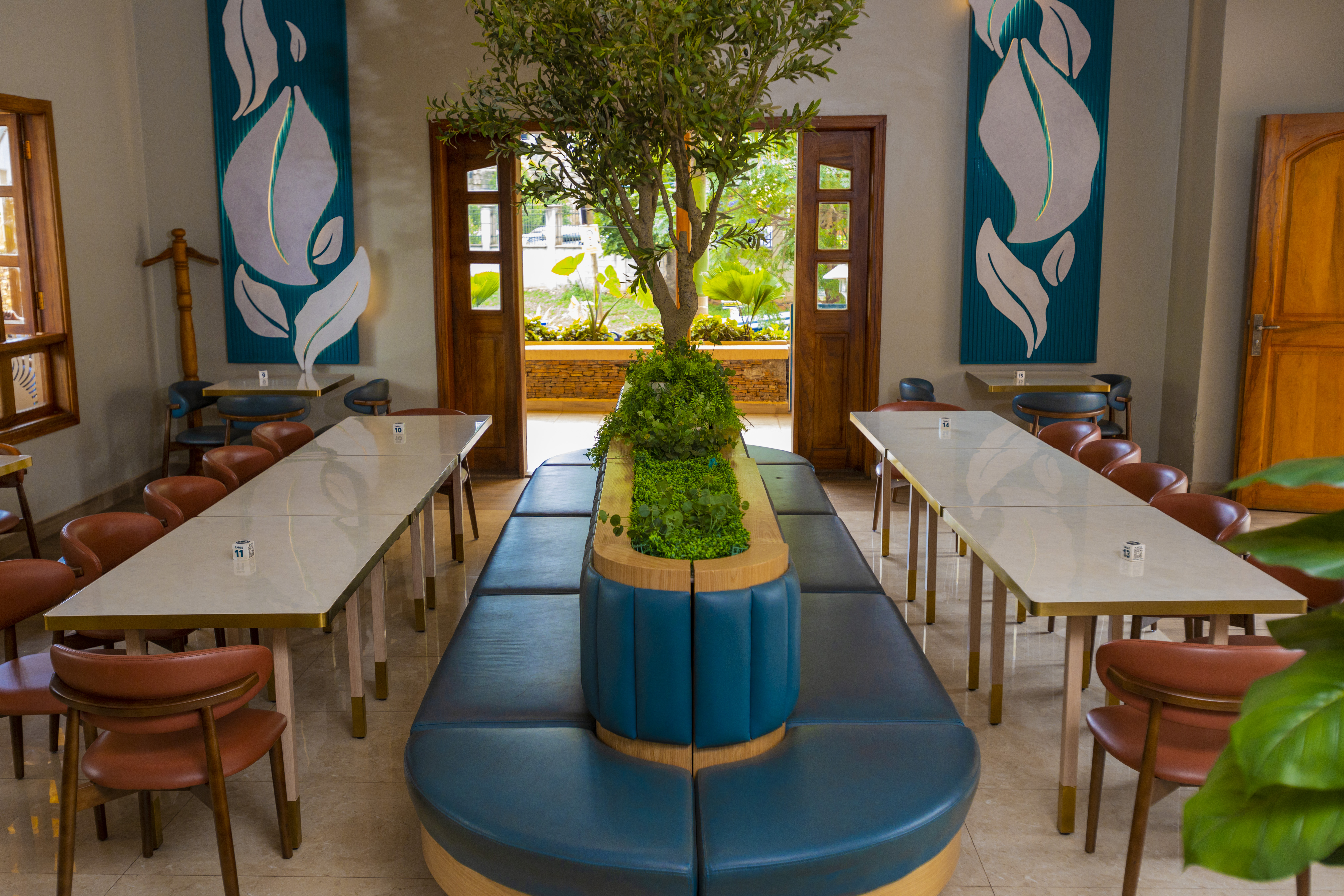 Inspire Cafe interior — warm seating and greenery